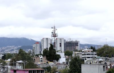 Buildings in city against sky