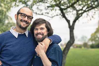 Portrait of affectionate gay couple at park