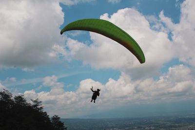 Person paragliding against sky