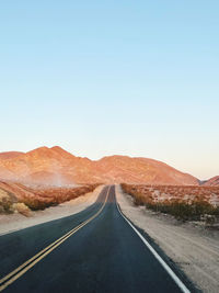 Empty road against clear sky