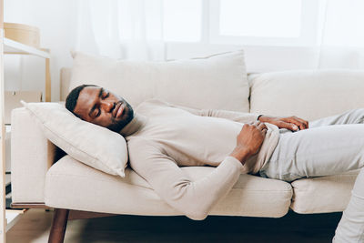 Young woman sleeping on bed at home