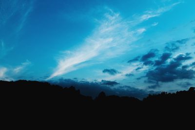 Silhouette of landscape against cloudy sky