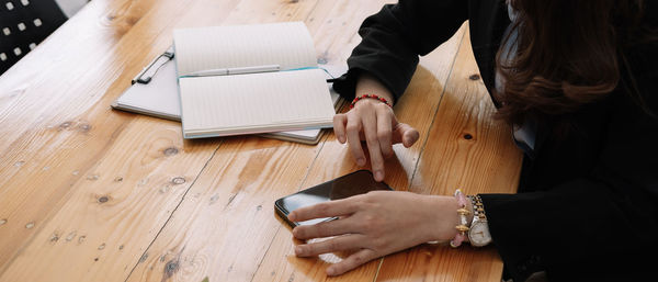 Midsection of woman using mobile phone