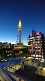 View of illuminated buildings against blue sky