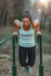 Exercising on parallel bar, outdoor gym