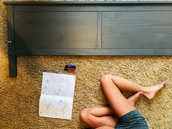 Low section of woman lying on floor