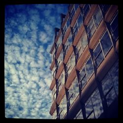 Low angle view of building against cloudy sky