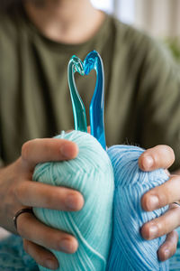 Midsection of woman holding heart shape