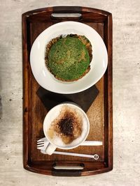 Top view of coffee with breakfast on wooden tray