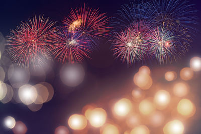 Low angle view of firework display at night