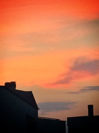 Low angle view of built structure against sky at sunset