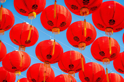 Low angle view of illuminated lanterns hanging at night