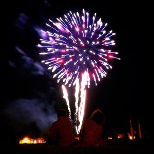 Low angle view of firework display at night