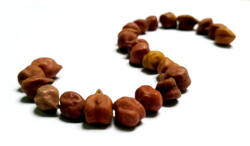 Close-up of coffee beans over white background