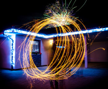 Light painting on street against illuminated building at night