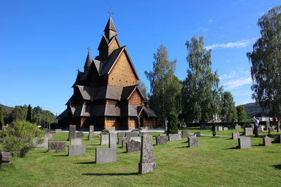 Tombstones and church against blue sky