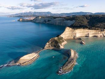 Aerial view of sea and rock formation against sky