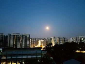 Illuminated city against sky at night