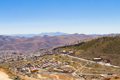 High angle view of mountains against clear blue sky