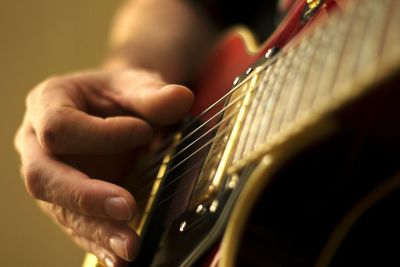 Close-up of person playing guitar