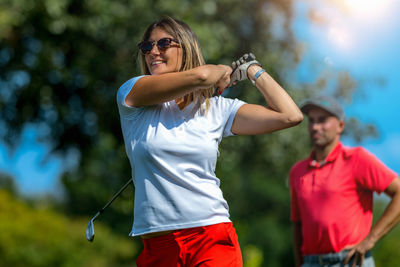 Two golfers, female and male playing golf