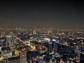 Aerial view of illuminated buildings in city at night