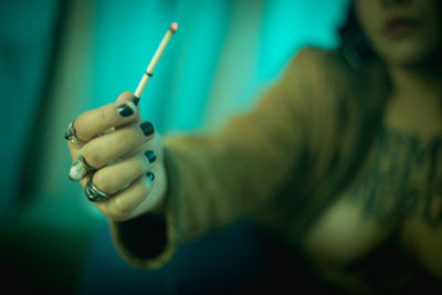 Close-up of man holding cigarette