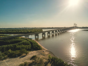 Pier over river against clear sky