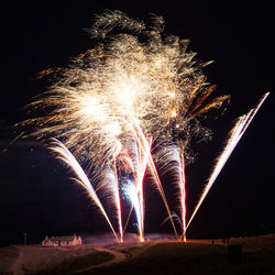 Low angle view of firework display at night