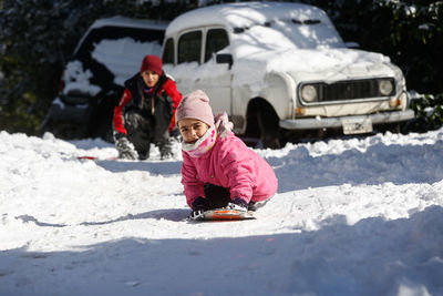 Rear view of girl with umbrella on snow