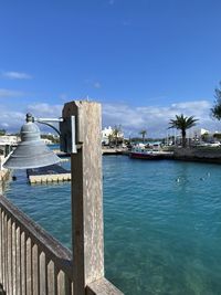 Pier over sea against blue sky