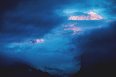 Low angle view of storm clouds over mountain