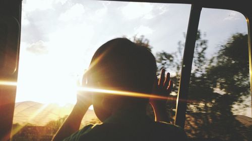 Close-up of boy looking through car window