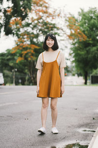 Portrait of a smiling young woman standing outdoors