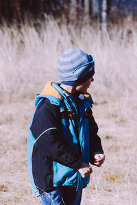 Cute boy standing on field