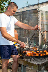 Man standing on barbecue grill