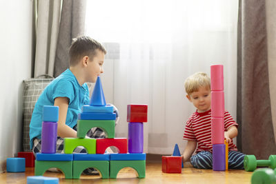 Portrait of boy playing with toys at home