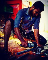 Close-up of man working at workshop