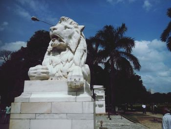 Low angle view of statue against cloudy sky