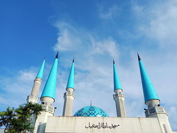 Low angle view of traditional building against blue sky