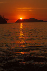 Scenic view of sea against romantic sky at sunset