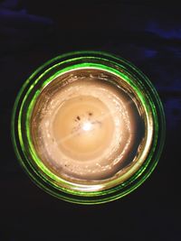 Close-up of illuminated lamp over black background