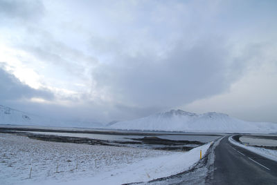 Panoramic view of road against sky during winter