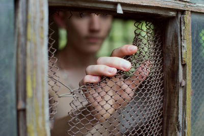 Close-up of man breaking window