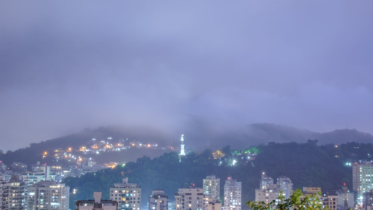 ILLUMINATED BUILDINGS AGAINST SKY AT NIGHT