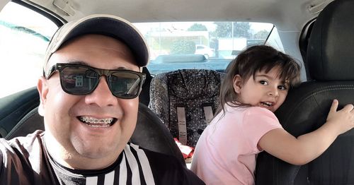 Portrait of happy woman sitting in car