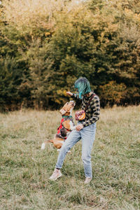 Rear view of woman standing on field whit her gog