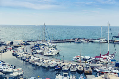 High angle view of boats moored on sea against sky