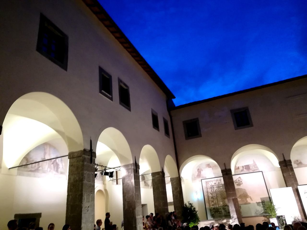 LOW ANGLE VIEW OF ILLUMINATED BUILDINGS AT NIGHT