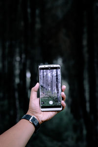 Midsection of person holding smart phone